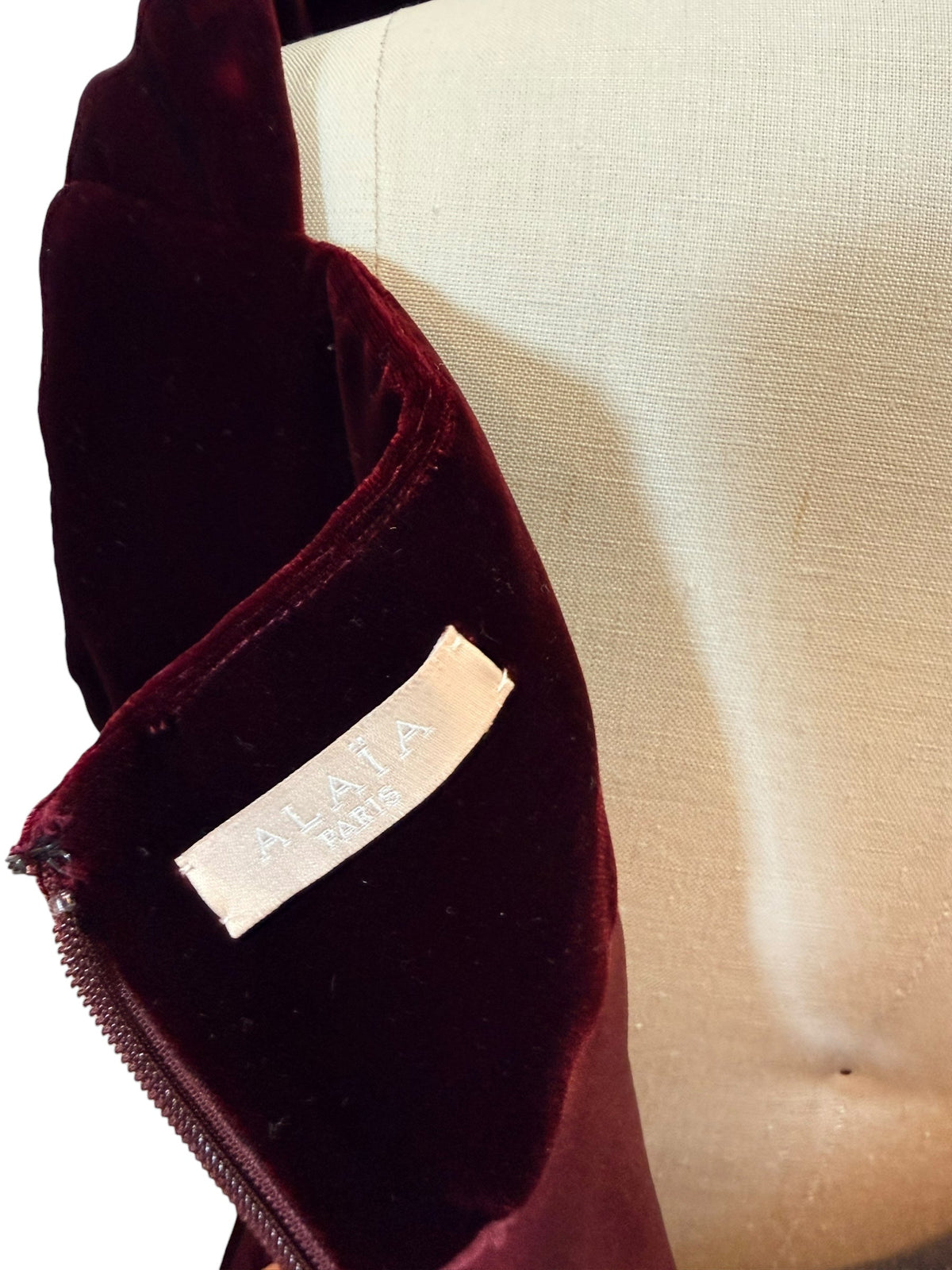 Alaïa label detail on burgundy velvet designer garment from Refined Concierge Consignment