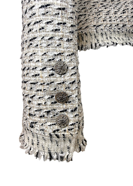 Close-up of Chanel logo sleeve buttons and fringe cuff detail on 2004 Lesage tweed jacket