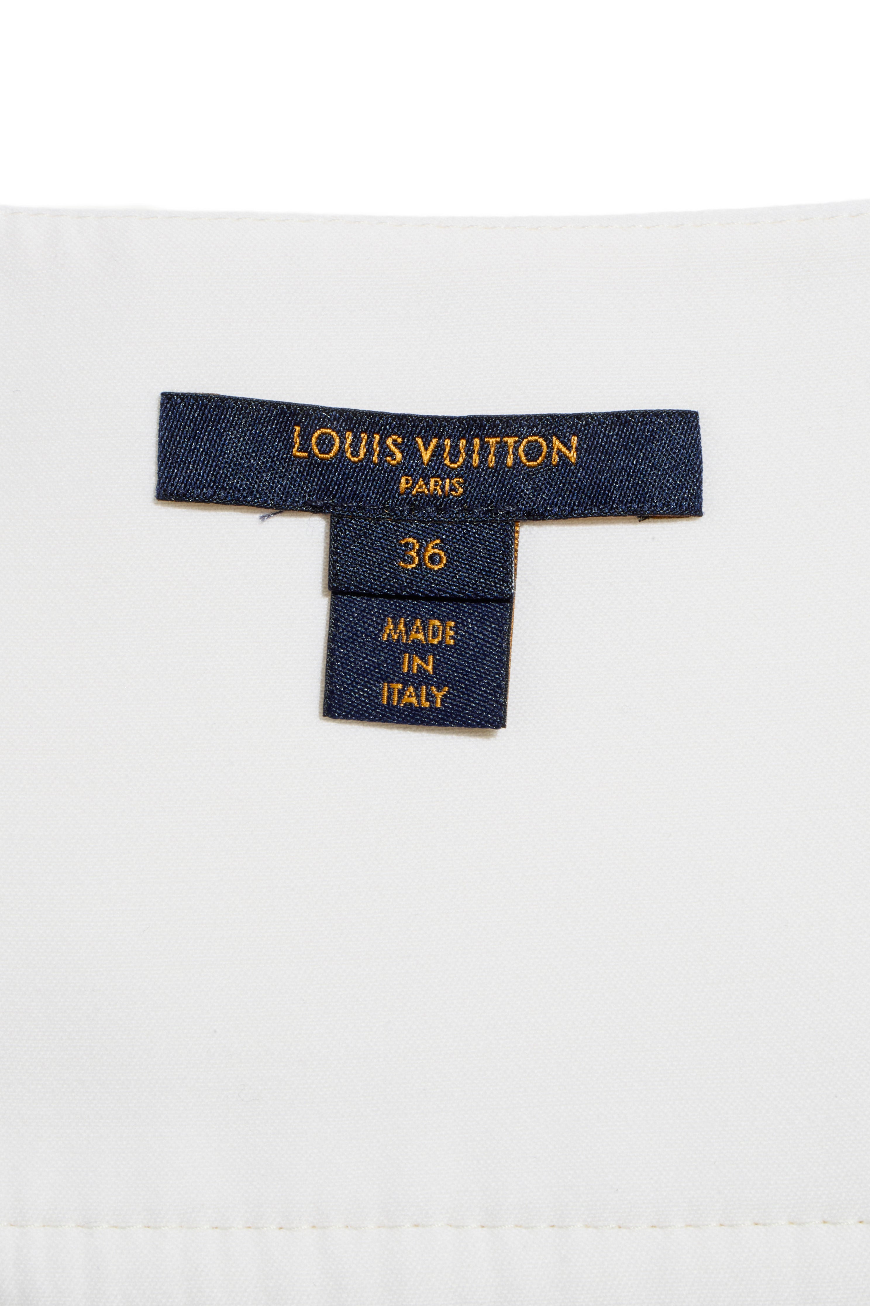Interior label of the Louis Vuitton white mini skirt, showing size FR 36 and Made in Italy craftsmanship.