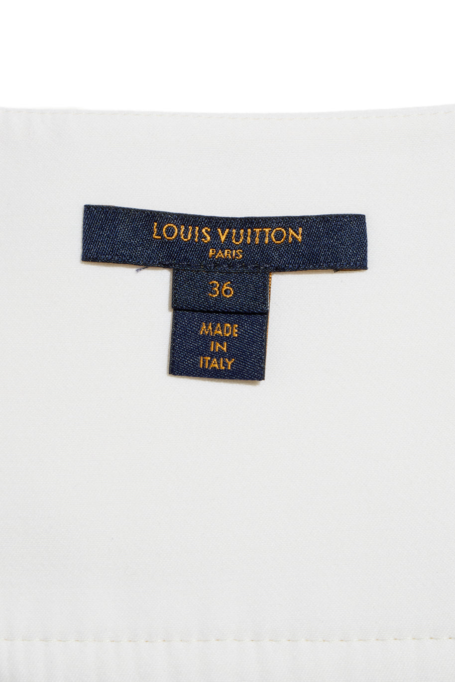 Interior label of the Louis Vuitton white mini skirt, showing size FR 36 and Made in Italy craftsmanship.