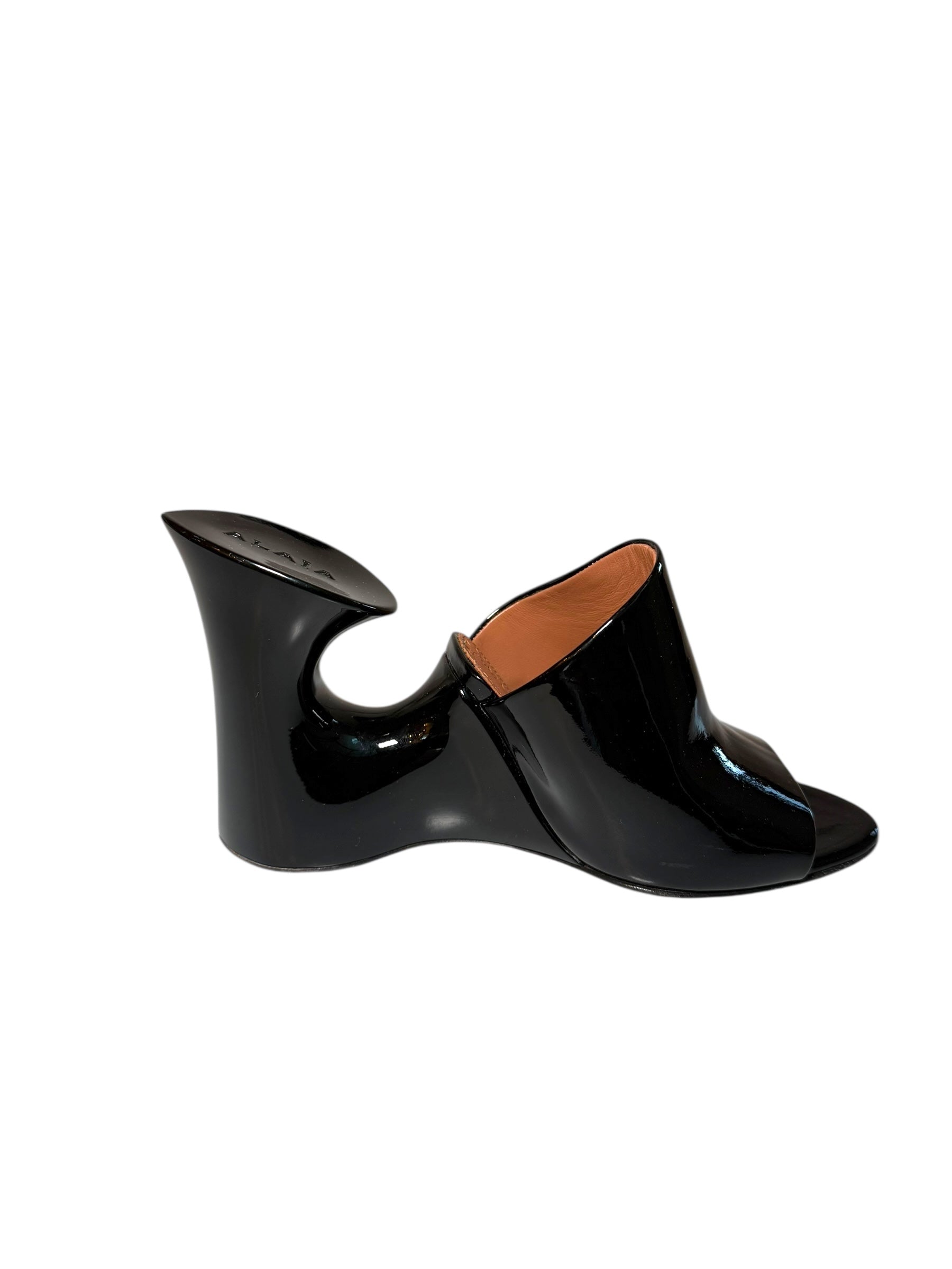 Alaia Black patent shoe with a unique sculptural design left shoe inside side view on a white background