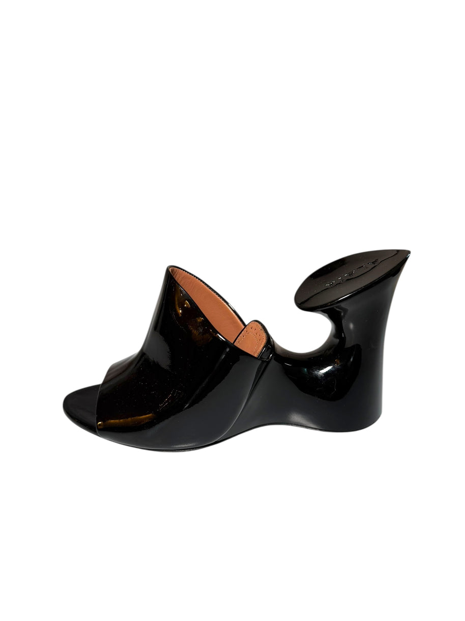 Alaia patent Black wedge mule left shoe side view on a white background