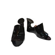 Alaia Black high-heeled patent black mule shoes with sculptural design on a white background main photo