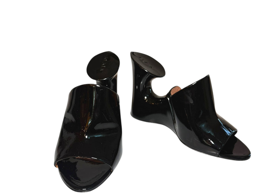 Alaia Black high-heeled patent black mule shoes with sculptural design on a white background main photo