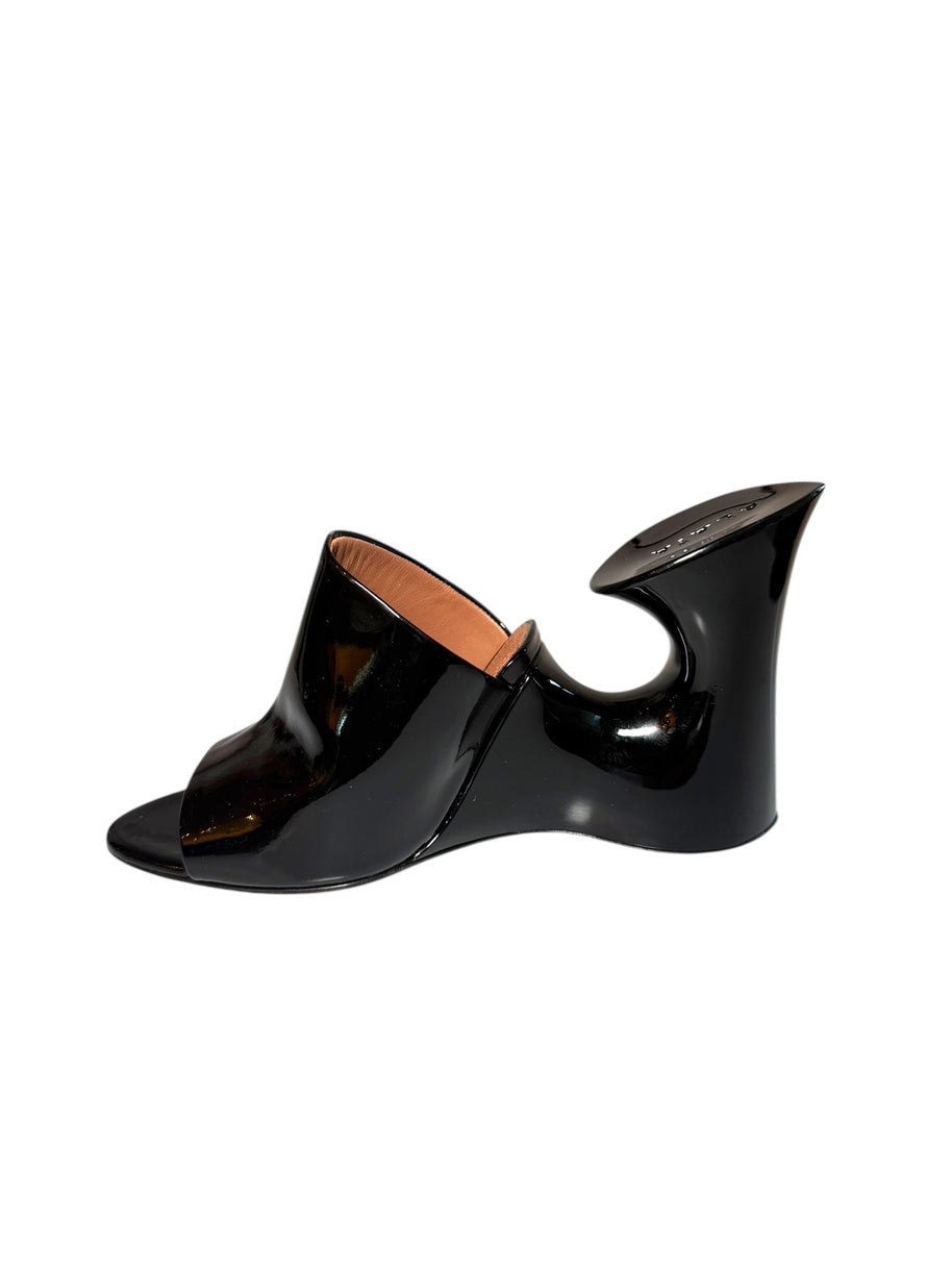 Black patent Alaia high-heeled mule wedge right shoe inside left view on a white background
