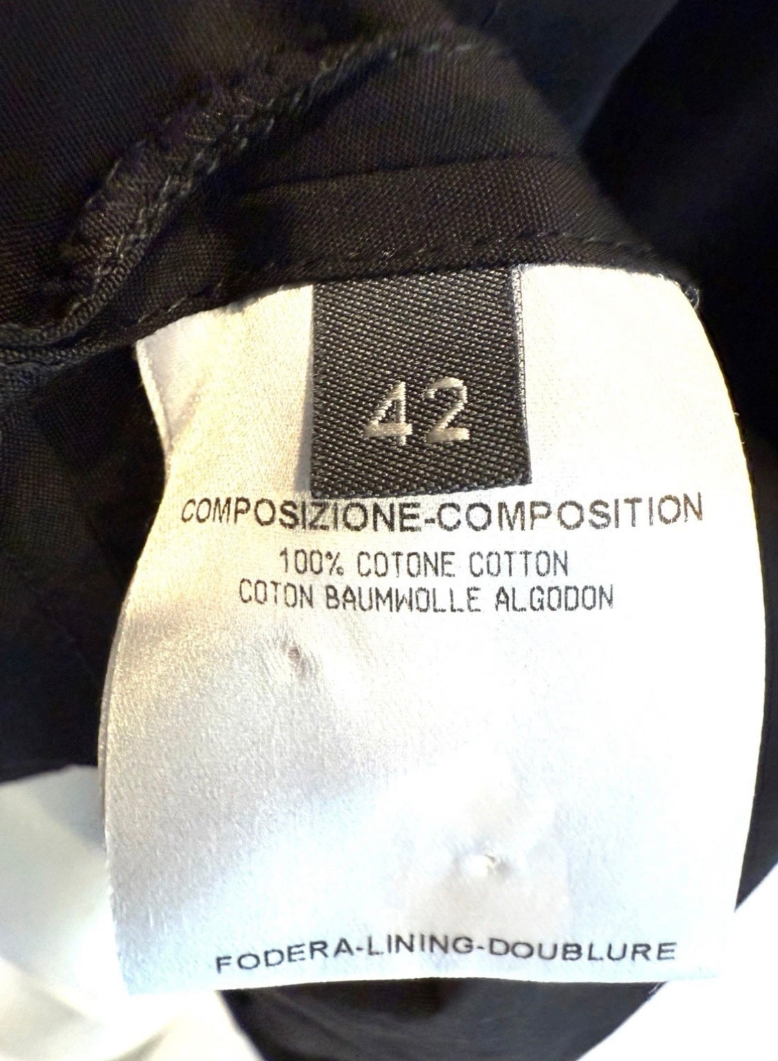 Alexander McQueen Black Shirt Dress Clothing label with size 42 and composition tag details on a black background