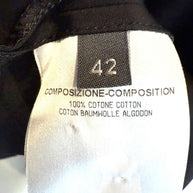 Alexander McQueen Black Shirt Dress Clothing label with size 42 and composition tag details on a black background