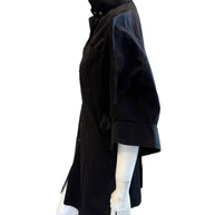 Alexander McQueen Black shirt dress detailing up close left side view on a mannequin against a white background