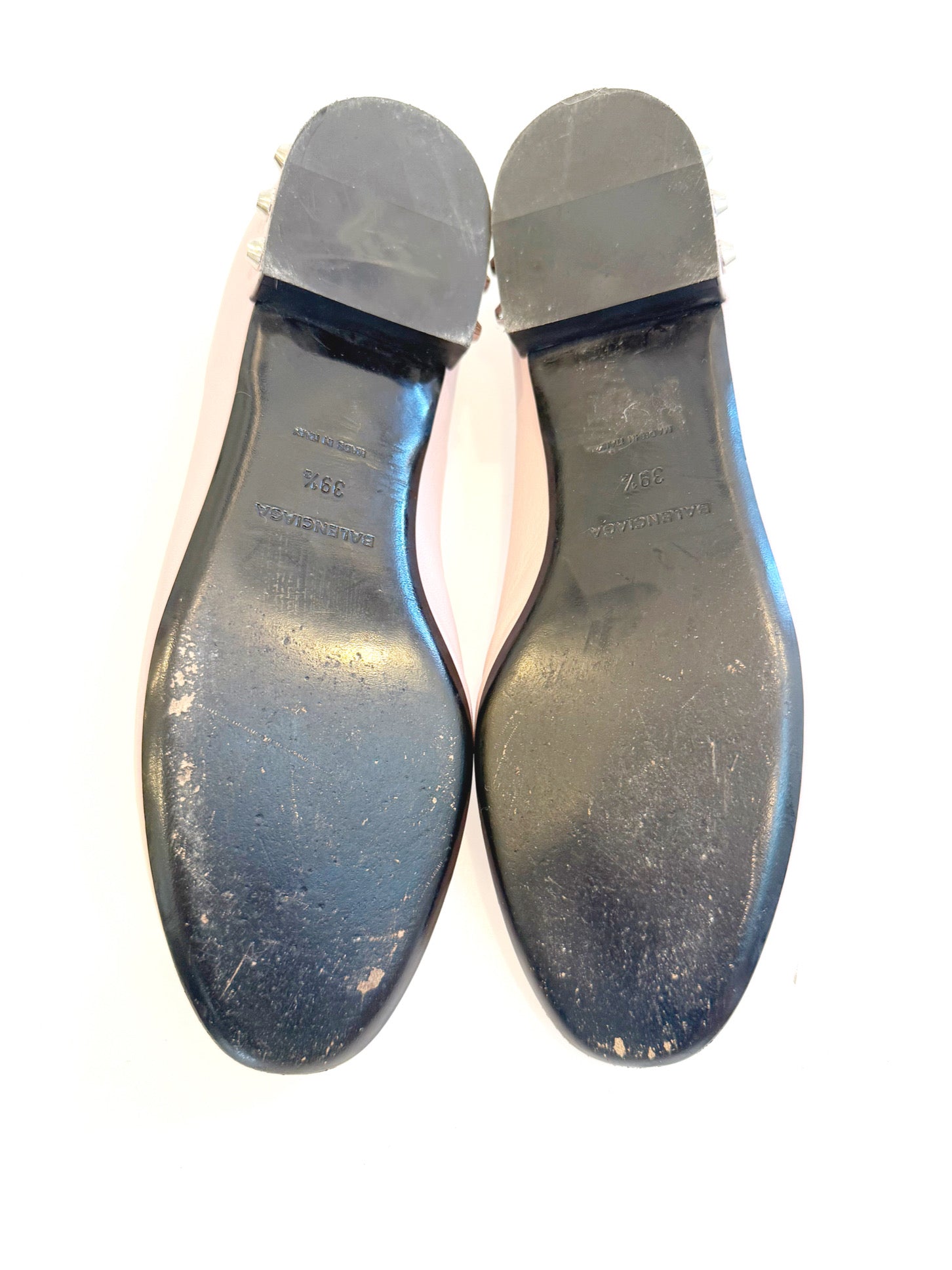 Bottom view of Balenciaga ballet flats displaying worn leather soles, size marking, and visible wear consistent with use.