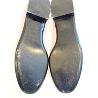 Bottom view of Balenciaga ballet flats displaying worn leather soles, size marking, and visible wear consistent with use.