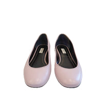 Front angle of Balenciaga powder pink lambskin ballet flats featuring rounded toes and smooth leather finish on a clean white background.