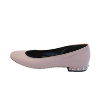 Outer profile view of Balenciaga powder pink lambskin ballet flats highlighting the rounded toe and silver studded heel design.