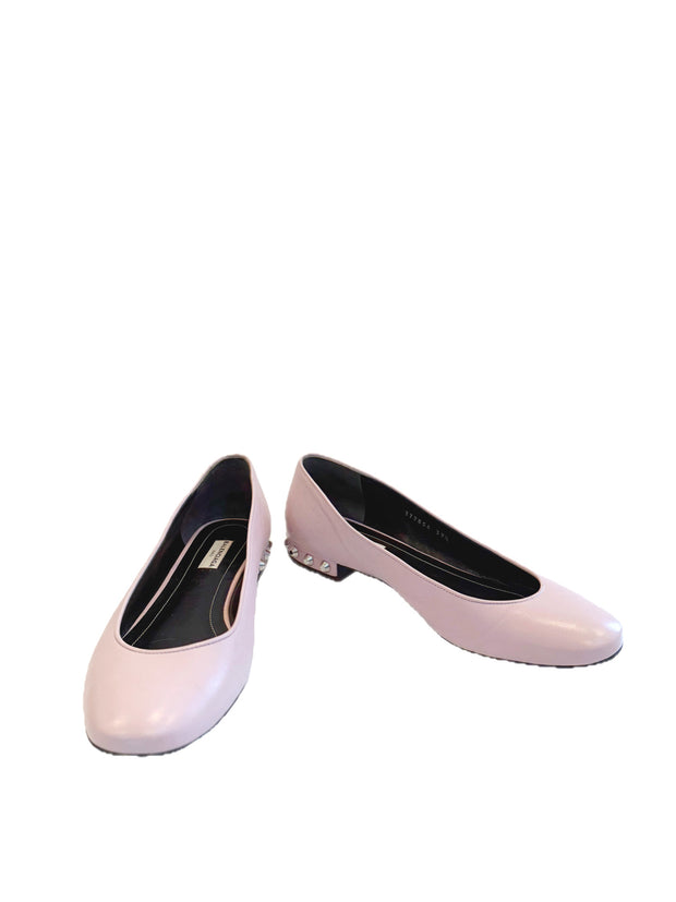Powder pink Balenciaga lambskin ballet flats shown side-by-side with silver studded heels and rounded toes on a white background.