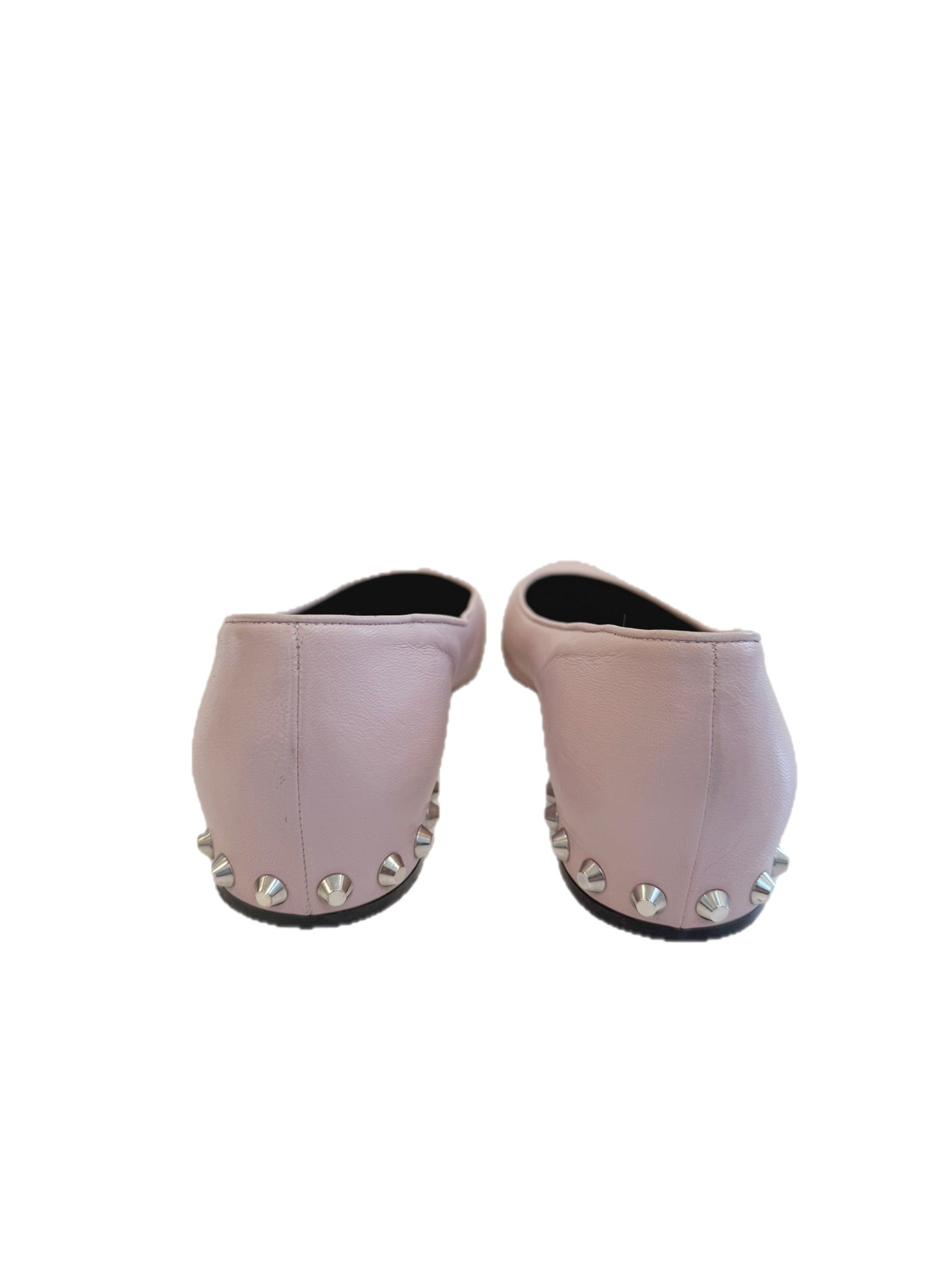 Rear view of Balenciaga ballet flats highlighting the silver cone studs across the low sculpted heels against a white backdrop.