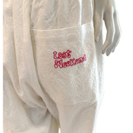 Close-up of pink “Lost Weekend” embroidery on the back pocket of the SS20 Bernhard Willhelm jumpsuit.