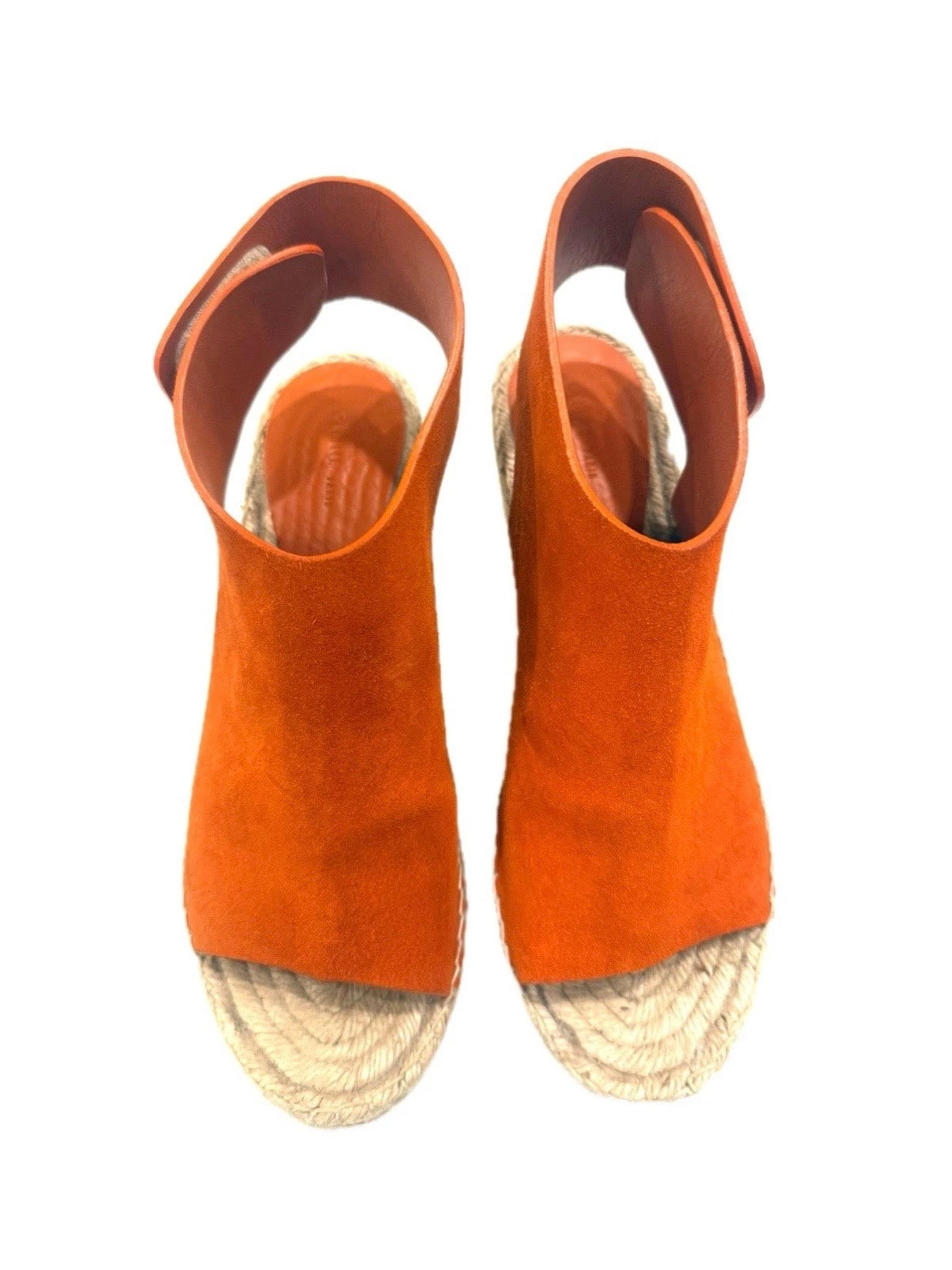 Top-down view of the Céline burnt orange suede wedges showing the wide suede vamp and Velcro slingback opening.