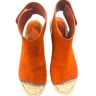 Top-down view of the Céline burnt orange suede wedges showing the wide suede vamp and Velcro slingback opening.