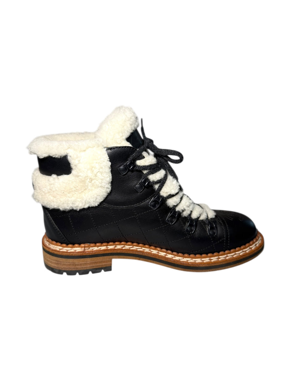 Chanel Quilted Black Leather and White Shearling Lined Hiking Boot Inside View of Left Shoe Black boot on a white background