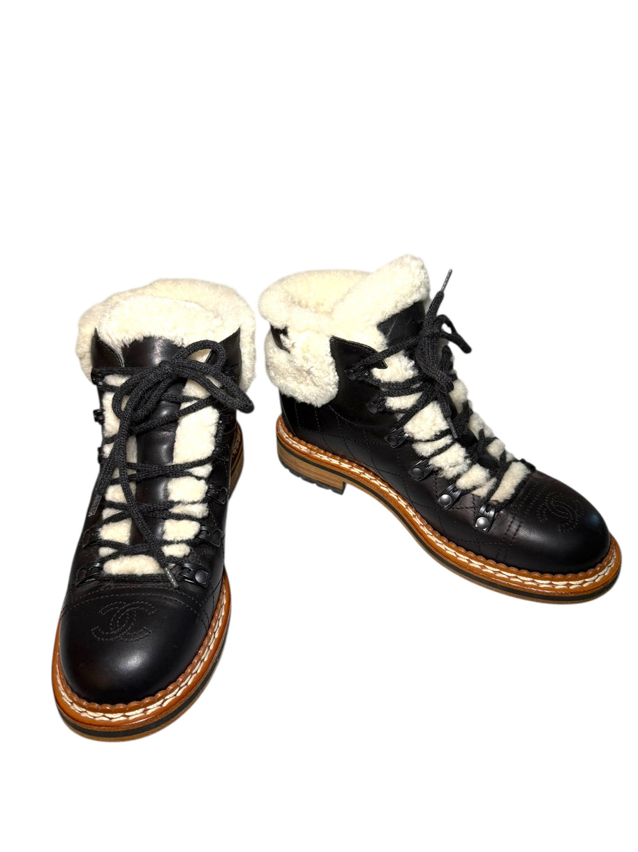Black quilted leather lace-up Chanel hiking boots with white fur lining size 38.5 main product photo on a white background
