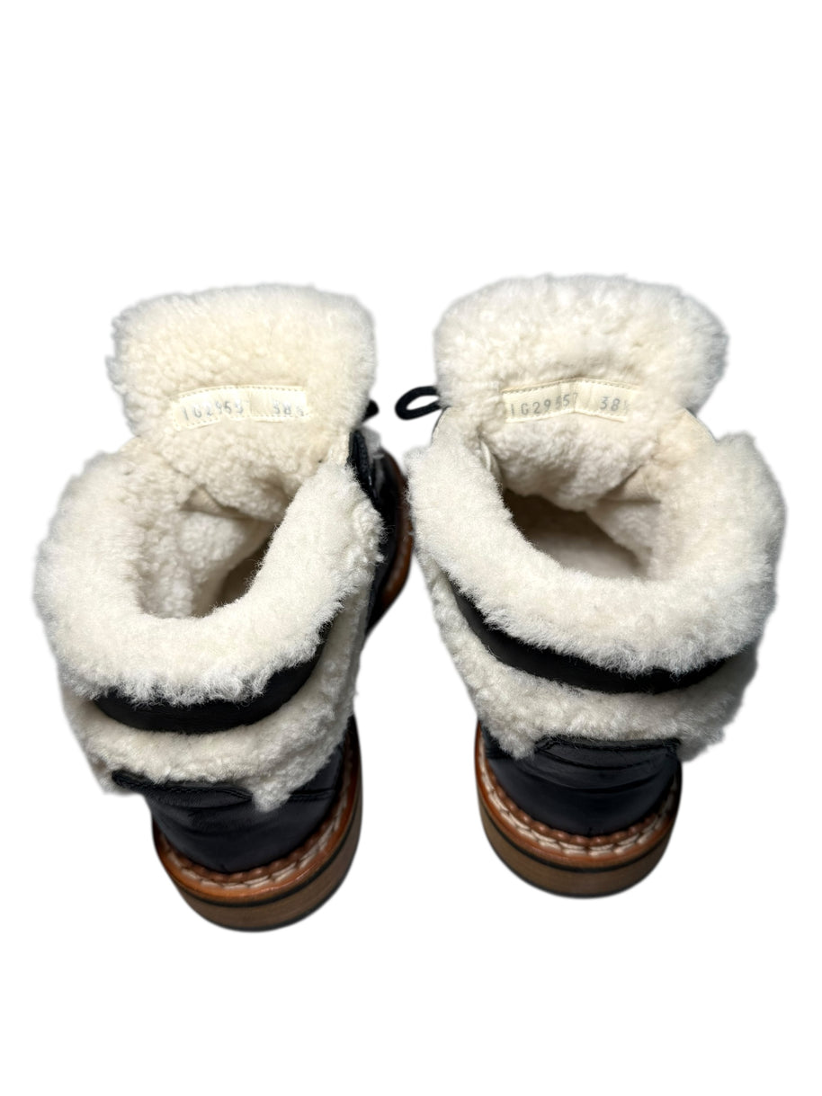 Chanel Quilted Black leather and shearling lined hiking boots Pair of boots with visible product label including style code and size of 38.5 in both shoes on a white background