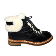 Chanel Quilted Black Leather boot with white shearling lining right shoe side view on a white background