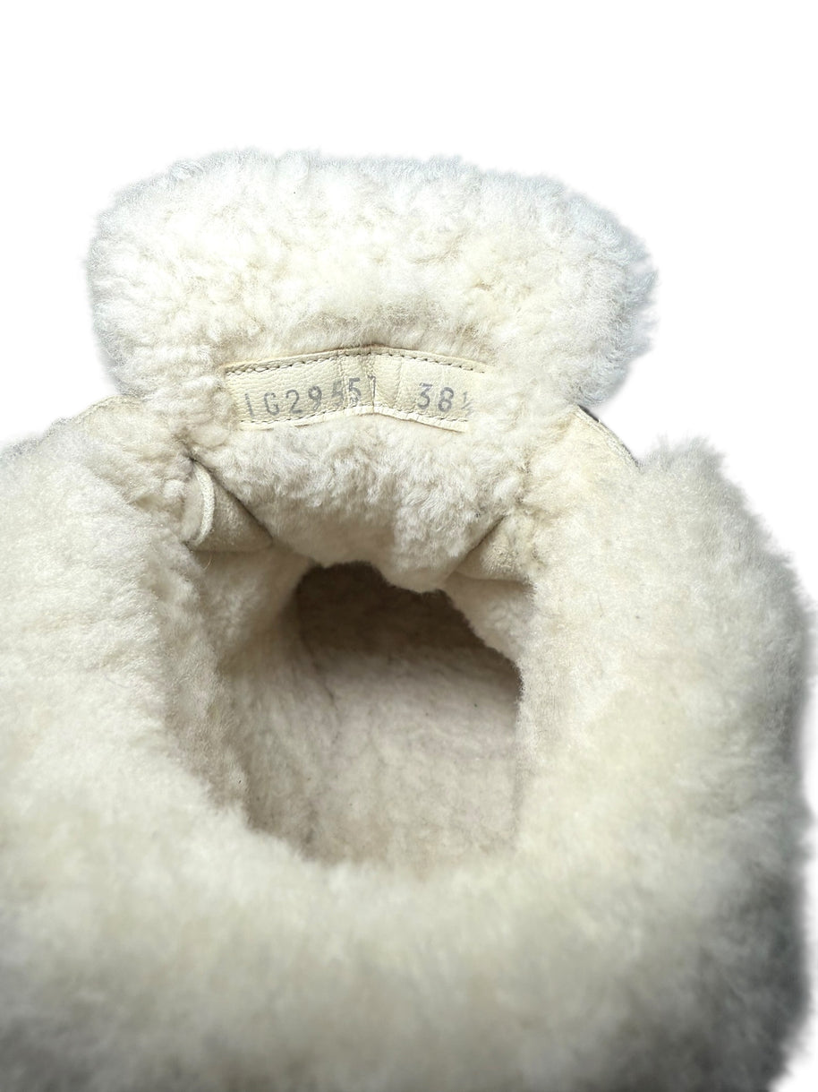 Chanel Black Quilted Shearling Hiking Boots Close-up of shearling lining with a visible product label and size of 38.5 on a white background