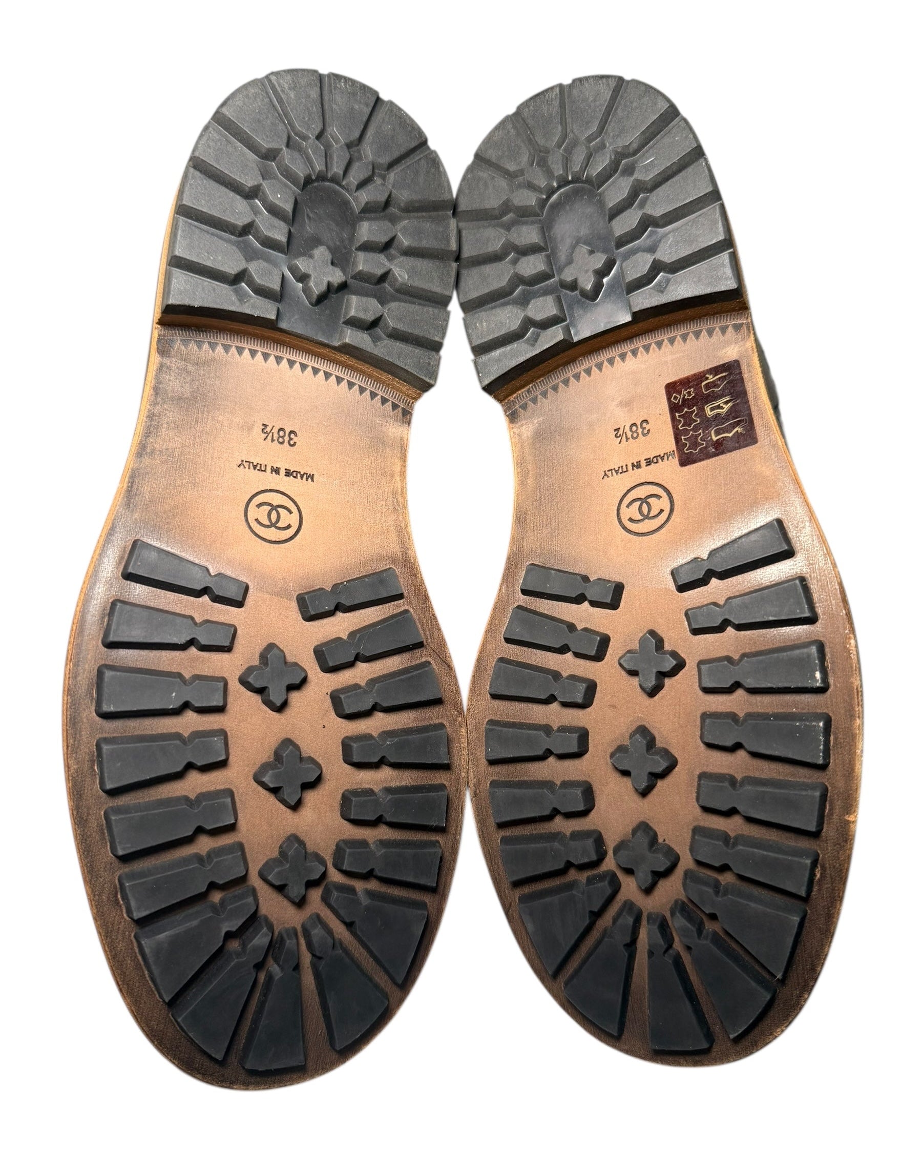 Chanel Quilted Black Shearling Hiking Boots Size 38.5 Close-up of brown leather shoe soles with a white background