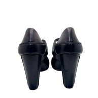 Rear view of Chanel block heel pumps showing heel shape and leather finish.