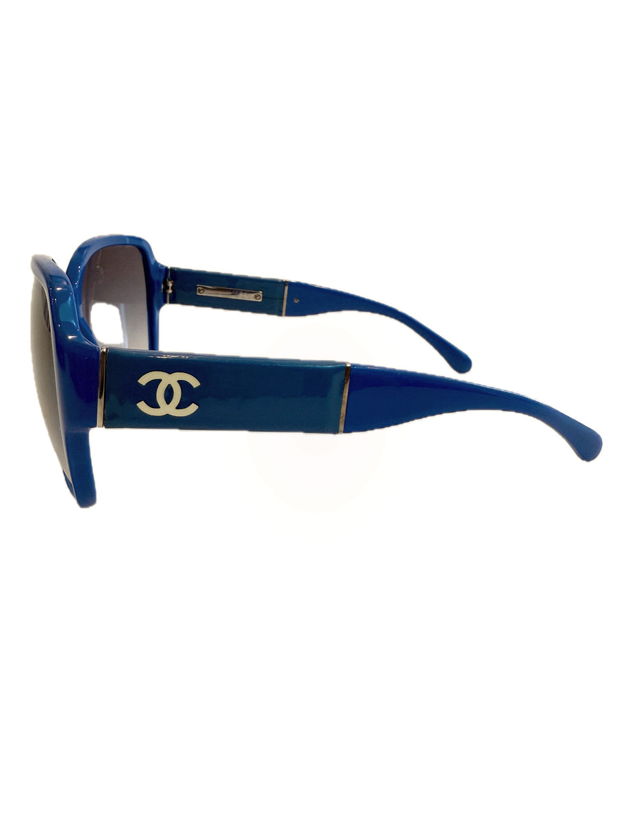 Right side angled view of Chanel blue sunglasses showing CC logo and curved temples.