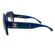 Right side angled view of Chanel blue sunglasses showing CC logo and curved temples.