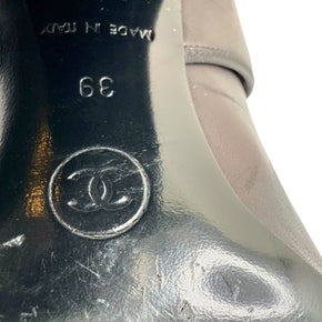Close-up of Chanel CC logo and size 39 stamped on sole of Mary Jane block heel pump.
