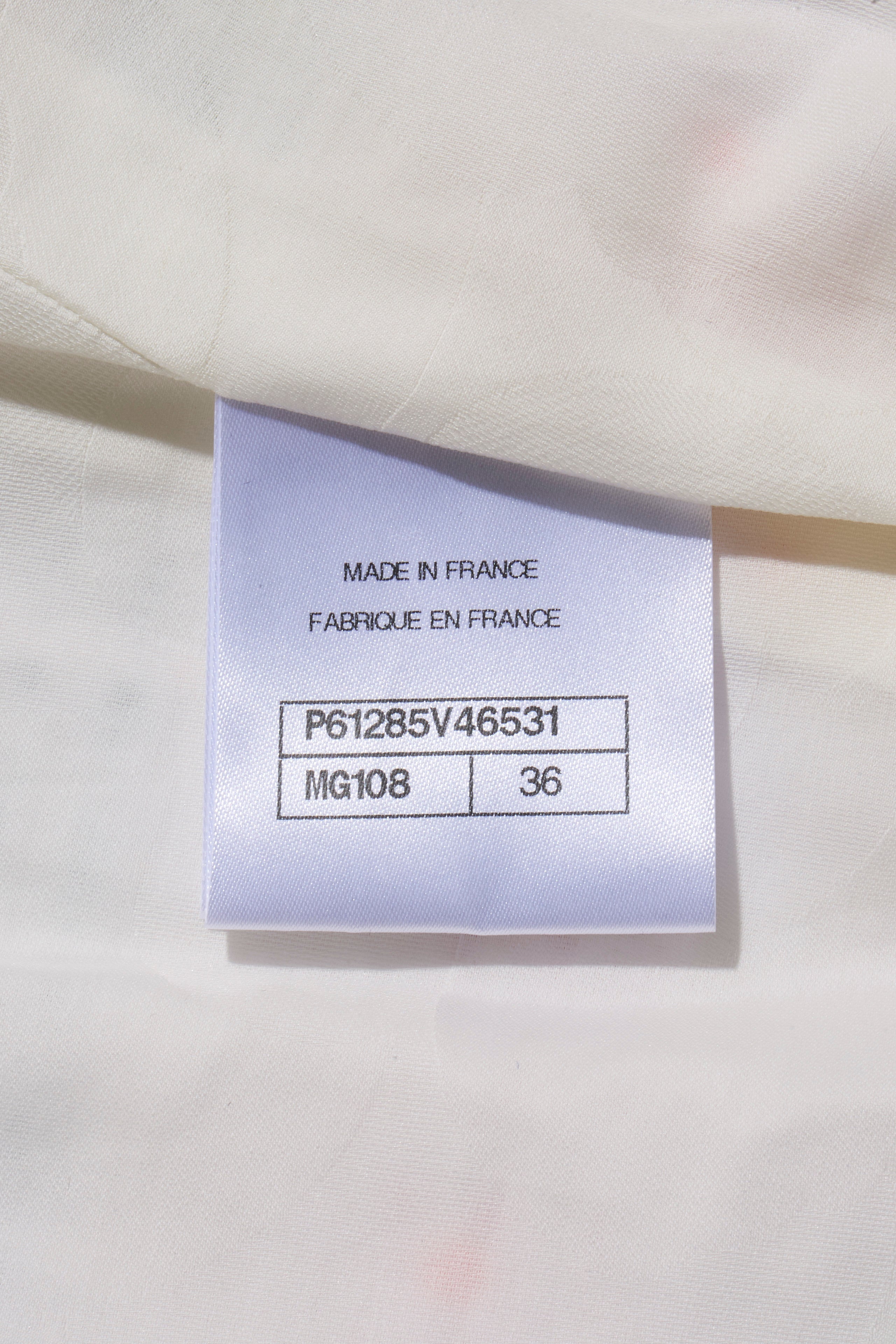 Chanel Fabrication label on a white fabric background with text 'MADE IN FRANCE' and product codes attached to Spring 2019 striped tweed coat.