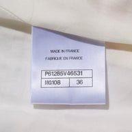 Chanel Fabrication label on a white fabric background with text 'MADE IN FRANCE' and product codes attached to Spring 2019 striped tweed coat.