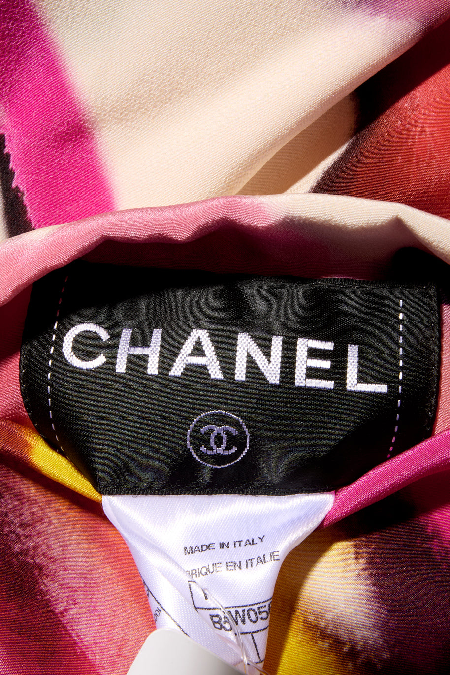 Close-up of a Chanel label on attached to the colorful floral print fabric 
