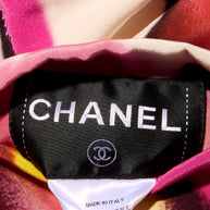 Close-up of a Chanel label on attached to the colorful floral print fabric 