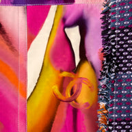 Close-up of Chanel colorful fabric with floral patterns and vibrant colors and iconic interlocking C's logo with tweed coat border.