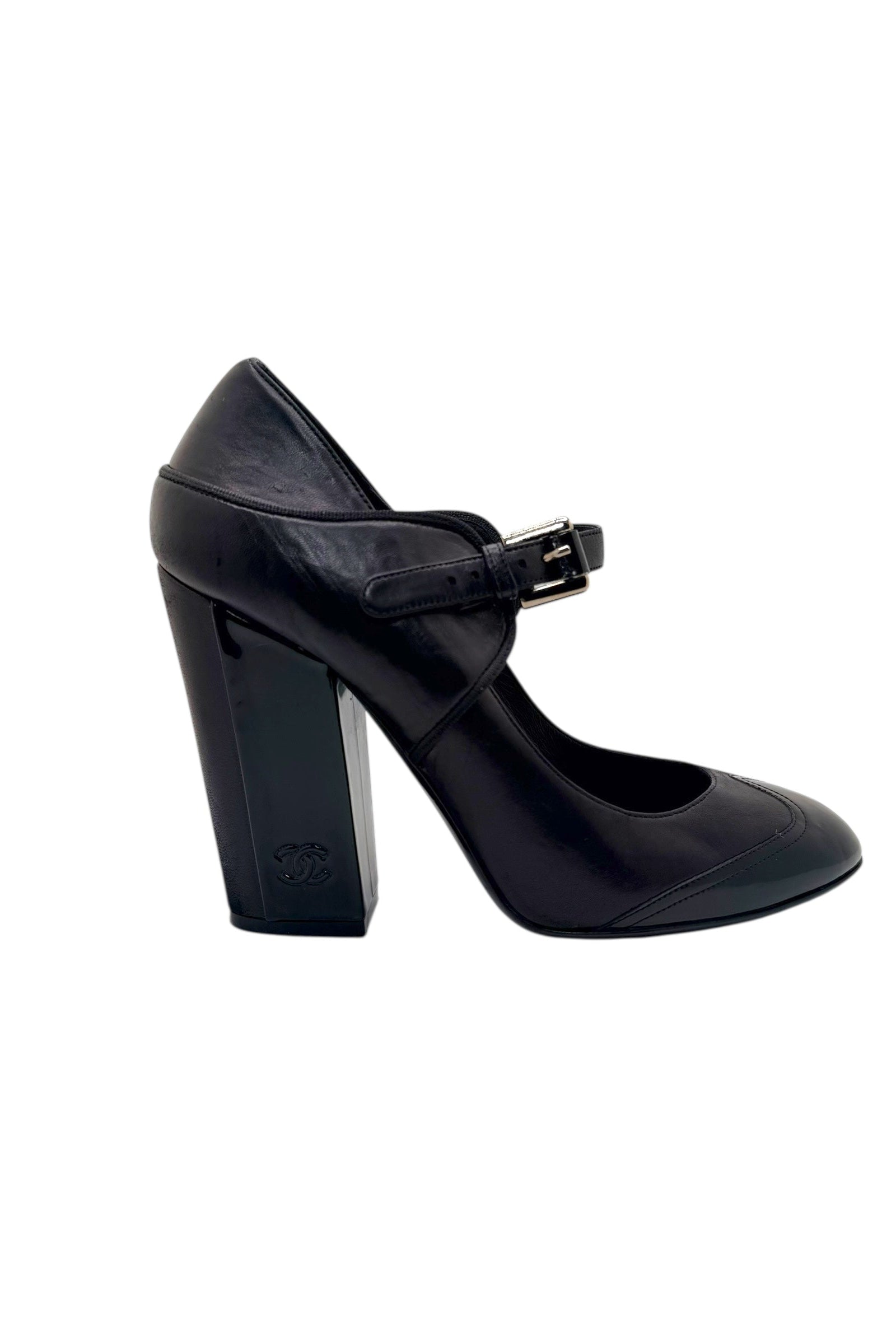 Single Chanel Mary Jane pump in black and brown leather showing block heel profile and rounded toe silhouette.