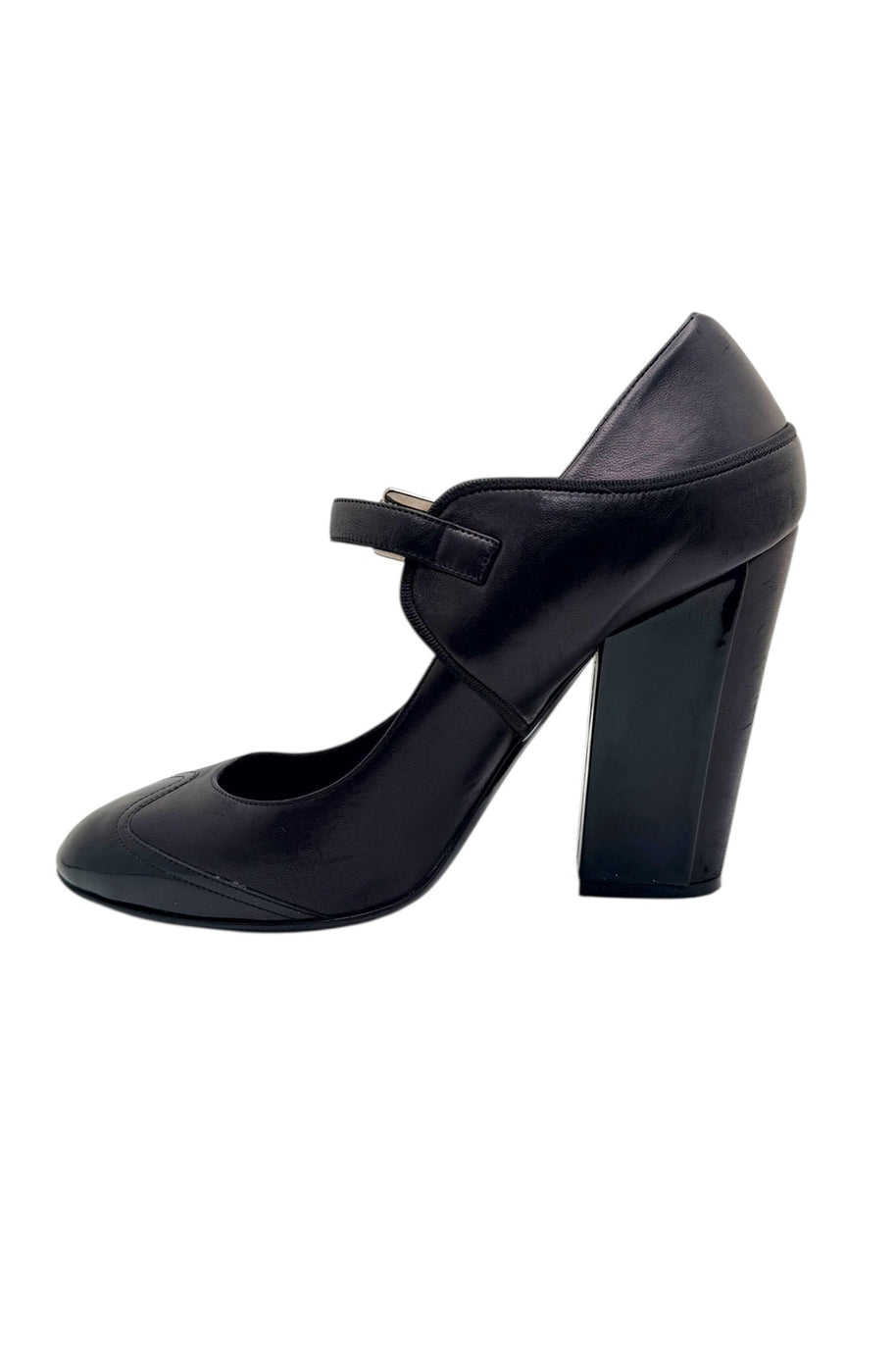 Front view of Chanel black leather Mary Jane pumps with glossy patent toe caps.