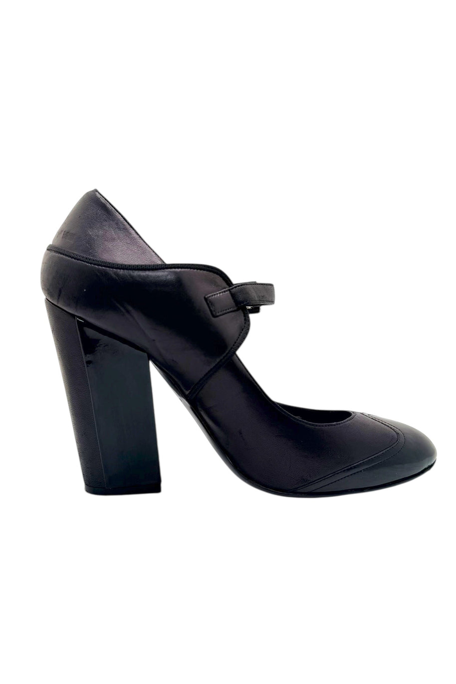 Full side view of Chanel Mary Jane pumps in black leather with patent toe and CC logo heel.