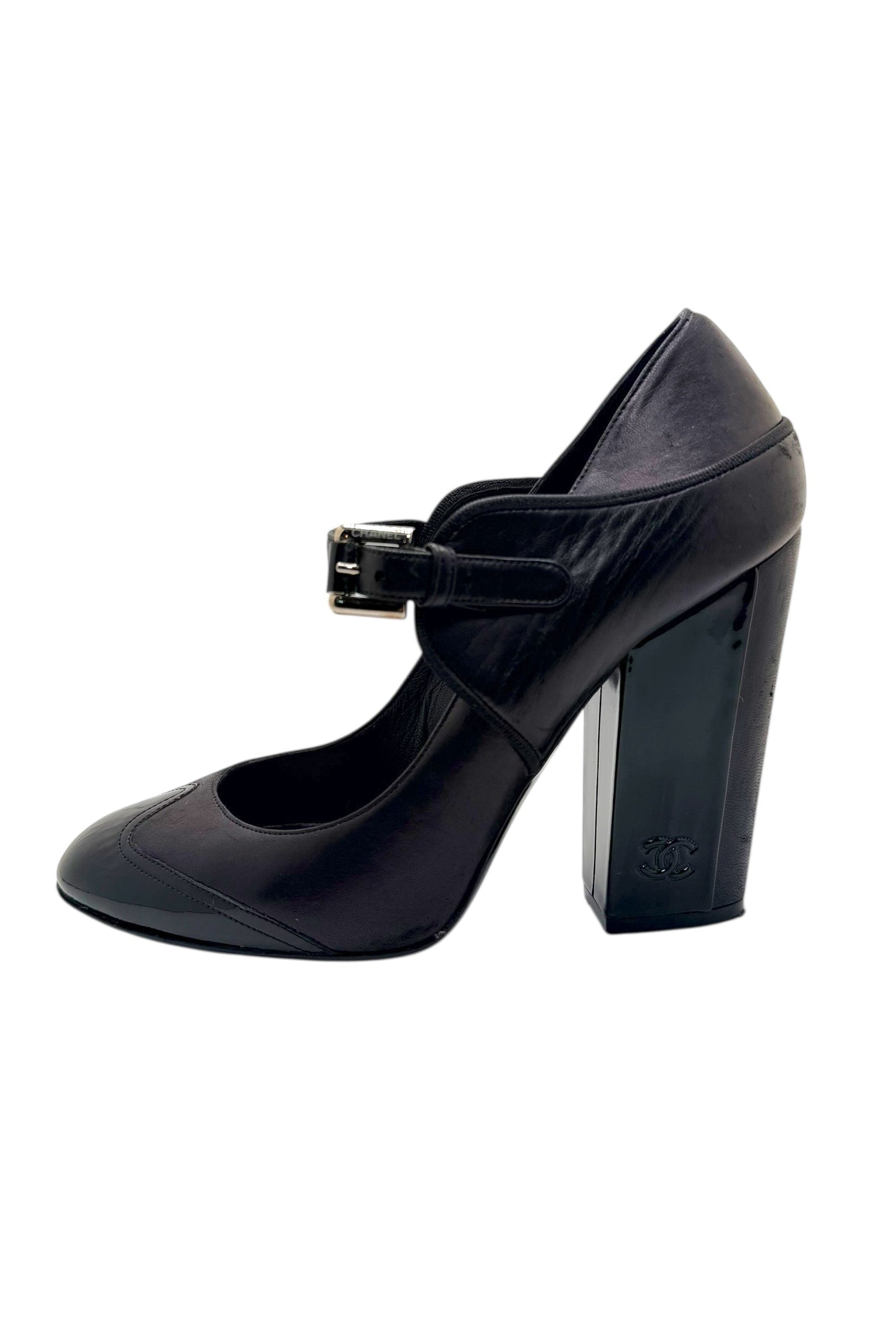 Angled side view of Chanel Mary Jane pumps highlighting block heel height and leather construction.
