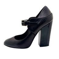 Angled side view of Chanel Mary Jane pumps highlighting block heel height and leather construction.