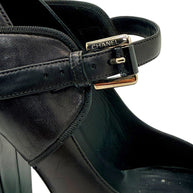 Close-up of Chanel Mary Jane strap with silver-tone buckle on black and brown leather pump.