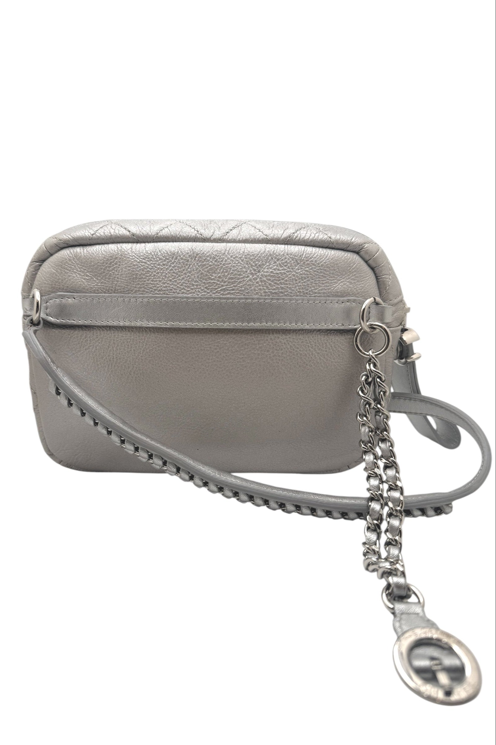Back view of Chanel metallic silver quilted bum bag with smooth leather panel, adjustable belt strap attachment points, and clean minimalist design.