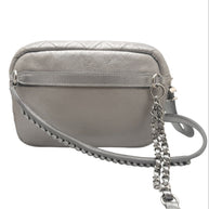 Back view of Chanel metallic silver quilted bum bag with smooth leather panel, adjustable belt strap attachment points, and clean minimalist design.