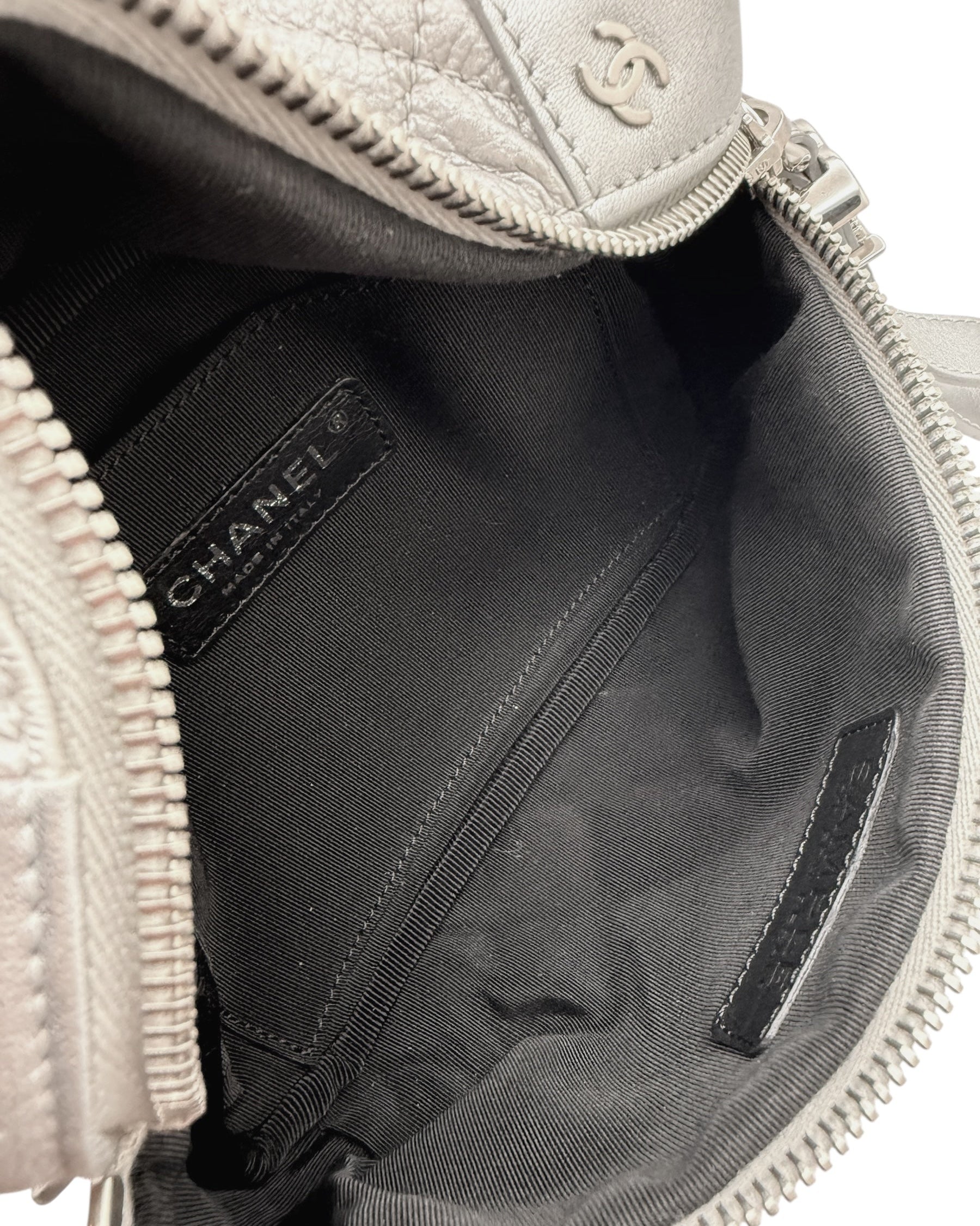 Interior pocket view of Chanel SS17 metallic silver bum bag featuring black textile lining and stitched interior compartment.