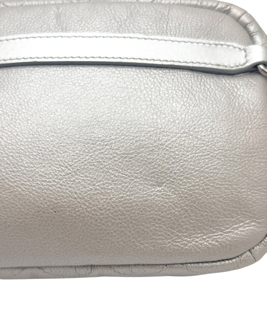 Close up view of Chanel SS17 metallic silver leather bum bag highlighting natural grain texture, stitching, and smooth leather panel detail.