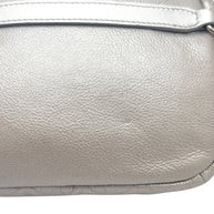 Close up view of Chanel SS17 metallic silver leather bum bag highlighting natural grain texture, stitching, and smooth leather panel detail.