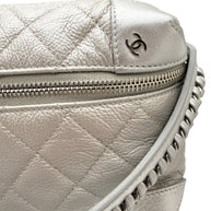 Close up of Chanel metallic silver quilted bum bag strap showing leather woven chain construction and refined stitching.