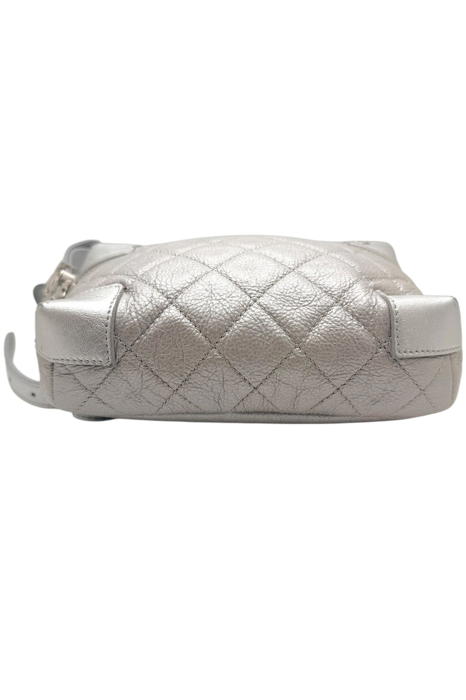 Bottom view of Chanel metallic silver quilted belt bag showing reinforced leather base corners and diamond quilted construction.