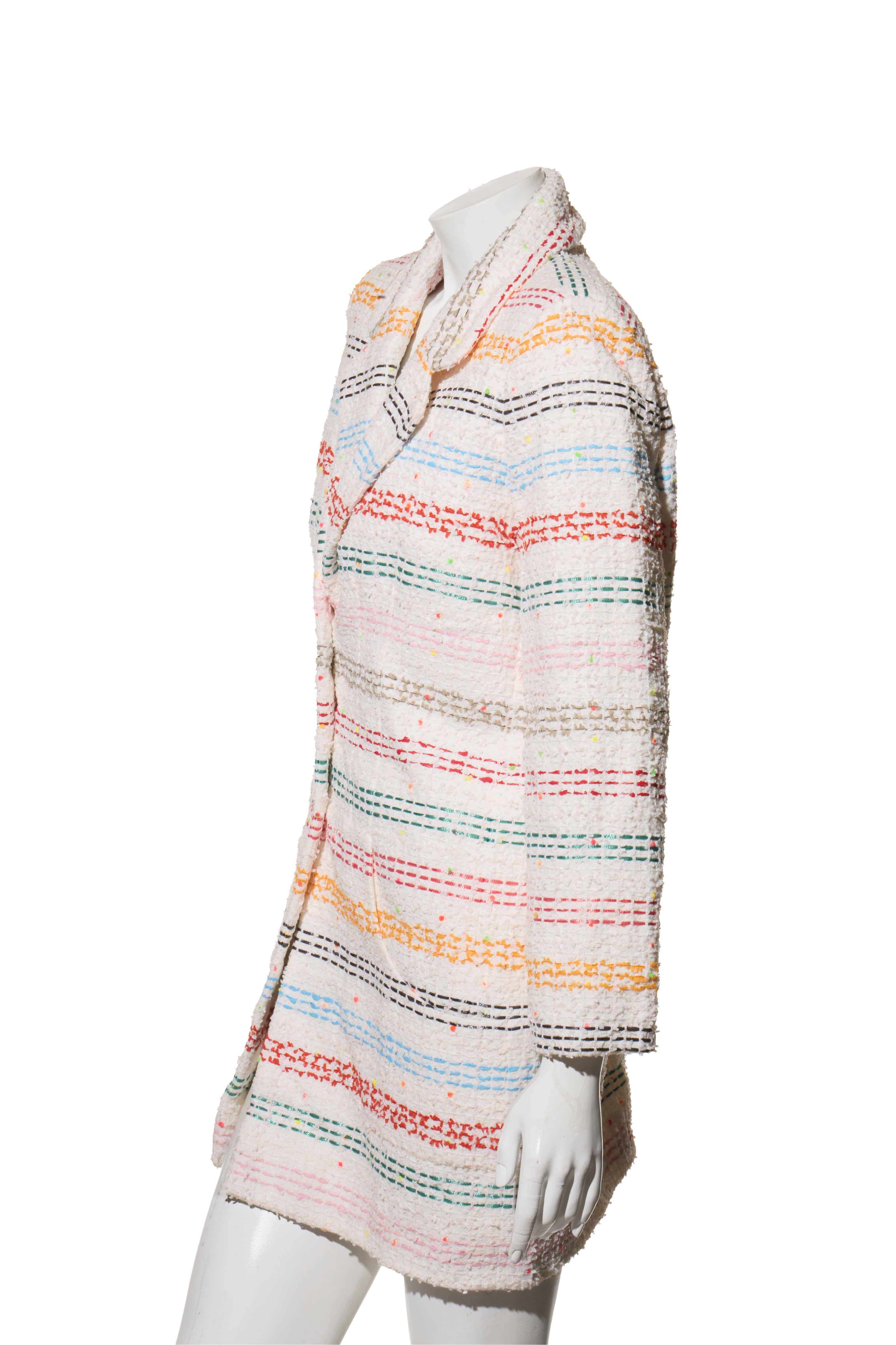 Chanel Rainbow Multicolored striped tweed coat on a mannequin against a white background left side view. 